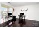 Bright home office with hardwood floors, dual workstations, and large windows, offering a productive and inviting workspace at 2577 Shoal Park Rd, Concord, NC 28027