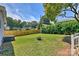 Well-maintained backyard with a fire pit, lush grass, and wooden fence at 3020 Stancill Pl, Charlotte, NC 28205
