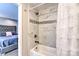 Updated bathroom featuring a shower-tub combo with decorative tile and a view into bedroom at 3020 Stancill Pl, Charlotte, NC 28205
