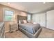 Comfortable bedroom featuring a padded headboard, soft carpet, and ample natural light at 3020 Stancill Pl, Charlotte, NC 28205
