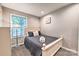 Bedroom with natural light and neutral decor, featuring hardwood floors and a stylish bed at 3020 Stancill Pl, Charlotte, NC 28205