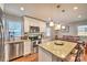 Bright kitchen features granite countertops, stainless steel appliances, and an island with barstool seating at 3020 Stancill Pl, Charlotte, NC 28205