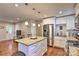 Open kitchen featuring a granite island, stainless steel refrigerator, subway tile backsplash, and white cabinets at 3020 Stancill Pl, Charlotte, NC 28205