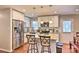 Modern kitchen featuring white cabinets, stainless steel appliances, and a granite countertop island with bar stools at 3020 Stancill Pl, Charlotte, NC 28205