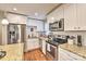 Kitchen featuring stainless appliances, granite countertops, subway tile backsplash, and bright, white cabinetry at 3020 Stancill Pl, Charlotte, NC 28205