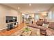 Open concept living area with hardwood floors, connecting the living room and kitchen at 3020 Stancill Pl, Charlotte, NC 28205