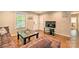 Comfortable living room with hardwood floors, a decorative coffee table, and ample seating at 3020 Stancill Pl, Charlotte, NC 28205