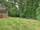 The backyard is beautifully landscaped with mature trees, creating a private oasis at 327 Whitestone Rd, Charlotte, NC 28270