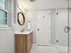 Updated bathroom with modern vanity, framed mirror, and walk-in shower with elegant glass door and subway tile at 327 Whitestone Rd, Charlotte, NC 28270