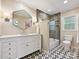 Modern bathroom featuring marble countertops, stylish geometric flooring, and glass shower at 327 Whitestone Rd, Charlotte, NC 28270