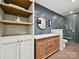 Modern bathroom with natural wood vanity, decorative mirror, and glass enclosed tiled shower at 327 Whitestone Rd, Charlotte, NC 28270