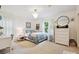 Bright bedroom featuring a queen-size bed, a large window, stylish decor and modern chandelier at 327 Whitestone Rd, Charlotte, NC 28270