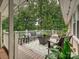 Outdoor deck area with comfortable seating, stylish rug, and a view of the surrounding greenery at 327 Whitestone Rd, Charlotte, NC 28270