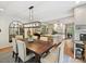 Bright dining area with a modern light fixture, a wooden table and upholstered chairs at 327 Whitestone Rd, Charlotte, NC 28270