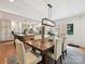 Open concept dining room, with a view to the kitchen and featuring a wooden table and upholstered chairs at 327 Whitestone Rd, Charlotte, NC 28270