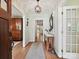 Welcoming entryway with hardwood floors, console table, and stylish light fixture at 327 Whitestone Rd, Charlotte, NC 28270