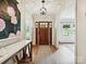 Welcoming foyer with hardwood floors, light walls, and wood front door at 327 Whitestone Rd, Charlotte, NC 28270