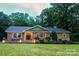 Charming brick home with a well-manicured lawn and cozy porch at 327 Whitestone Rd, Charlotte, NC 28270