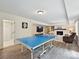 Spacious game room features a fireplace, built-in shelving, hardwood floors and ping pong table at 327 Whitestone Rd, Charlotte, NC 28270