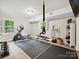 Well-equipped home gym with exercise machines, weights, and plenty of room for a complete workout routine at 327 Whitestone Rd, Charlotte, NC 28270
