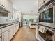 Bright, updated kitchen with stainless steel appliances, white cabinets, and an open layout to dining area at 327 Whitestone Rd, Charlotte, NC 28270