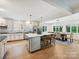 Bright kitchen with white cabinets, stainless steel appliances, large island, and adjacent dining area at 327 Whitestone Rd, Charlotte, NC 28270