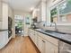 White kitchen featuring granite countertops, white cabinets, and stainless steel appliances at 327 Whitestone Rd, Charlotte, NC 28270