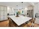 Spacious kitchen boasts white cabinets, a large island with seating, and modern stainless steel appliances at 327 Whitestone Rd, Charlotte, NC 28270