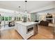 Spacious kitchen features an island with a microwave and wine fridge, next to the living and dining rooms at 327 Whitestone Rd, Charlotte, NC 28270