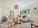 Cozy living room featuring a large window, neutral decor, and comfortable seating at 327 Whitestone Rd, Charlotte, NC 28270