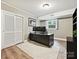Efficient office space features built-in shelving, a window, and neutral colors for a comfortable work environment at 327 Whitestone Rd, Charlotte, NC 28270
