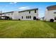 A well-maintained backyard with a spacious lawn and view of the home's rear exterior at 334 Kennerly Center Dr, Mooresville, NC 28115