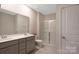 Bathroom featuring a double sink vanity, glass-enclosed shower, and a private toilet at 334 Kennerly Center Dr, Mooresville, NC 28115