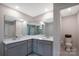 Bathroom featuring double sink vanity, tile floor, and large mirrors at 334 Kennerly Center Dr, Mooresville, NC 28115