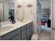 Bathroom with double vanity, gray cabinetry, decor, and access to an adjacent bedroom at 334 Kennerly Center Dr, Mooresville, NC 28115