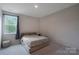 Cozy bedroom with neutral walls, a large window, and a platform bed at 334 Kennerly Center Dr, Mooresville, NC 28115