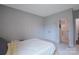 Simple bedroom with light gray walls, carpet, a double closet, and access to a bathroom at 334 Kennerly Center Dr, Mooresville, NC 28115