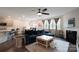 Open concept living room with a fireplace, dark blue sofa, and access to the dining area and kitchen at 334 Kennerly Center Dr, Mooresville, NC 28115