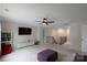 Open loft area with a sofa, TV, bookshelves, and a ceiling fan at 334 Kennerly Center Dr, Mooresville, NC 28115