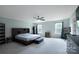 Spacious main bedroom featuring carpet, ceiling fan, large windows, and dark wood furnishings at 334 Kennerly Center Dr, Mooresville, NC 28115