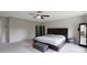 Main bedroom with large bed with headboard, dark wood furnishings, ceiling fan, and carpeting at 334 Kennerly Center Dr, Mooresville, NC 28115