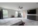 Bright main bedroom with large window, ceiling fan, carpeting, and television mounted on wall at 334 Kennerly Center Dr, Mooresville, NC 28115
