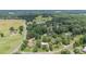 Picturesque aerial view of the property surrounded by green fields and mature trees at 3980 English Oak Dr, Lincolnton, NC 28092