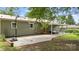 Backyard with a concrete patio area, outdoor seating under a covered porch, and basketball hoop at 3980 English Oak Dr, Lincolnton, NC 28092