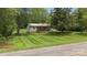 Charming home with a metal roof, covered front porch and a meticulously maintained front lawn at 3980 English Oak Dr, Lincolnton, NC 28092