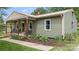 Inviting home exterior with a covered front porch, mature landscaping, and a well-maintained lawn at 3980 English Oak Dr, Lincolnton, NC 28092