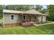 Charming single-story home with a welcoming front porch, green lawn, and mature trees at 3980 English Oak Dr, Lincolnton, NC 28092