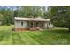 Charming home featuring a welcoming porch, beautifully maintained lawn, and a classic metal roof at 3980 English Oak Dr, Lincolnton, NC 28092