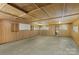Empty garage interior with concrete floor and wood paneled walls, ready for storage or customization at 3980 English Oak Dr, Lincolnton, NC 28092