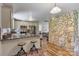 Open kitchen features granite countertops, stainless appliances, and an eye-catching stacked stone accent wall at 3980 English Oak Dr, Lincolnton, NC 28092